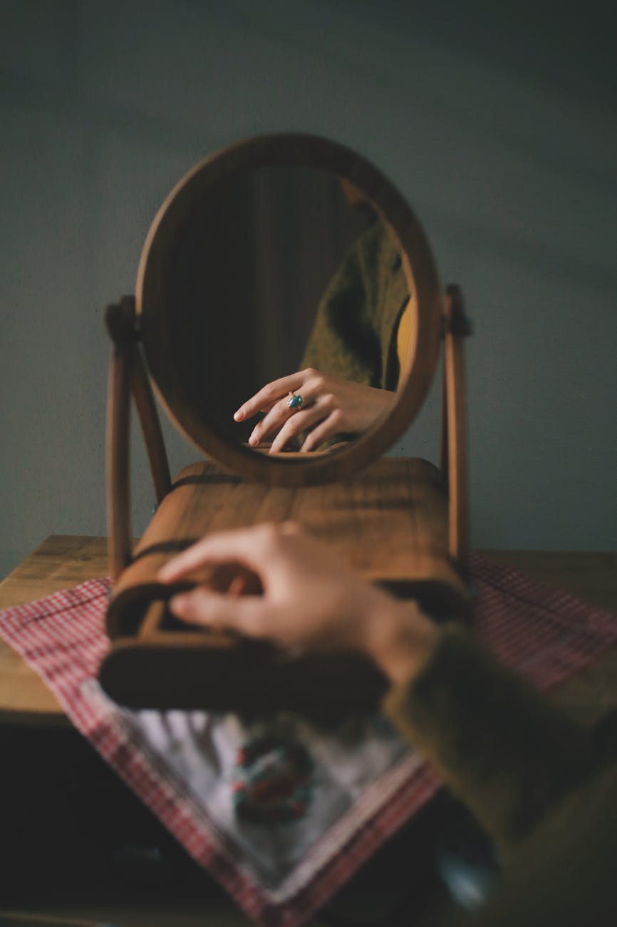 reflection of a womans hand with a blue stone ring
